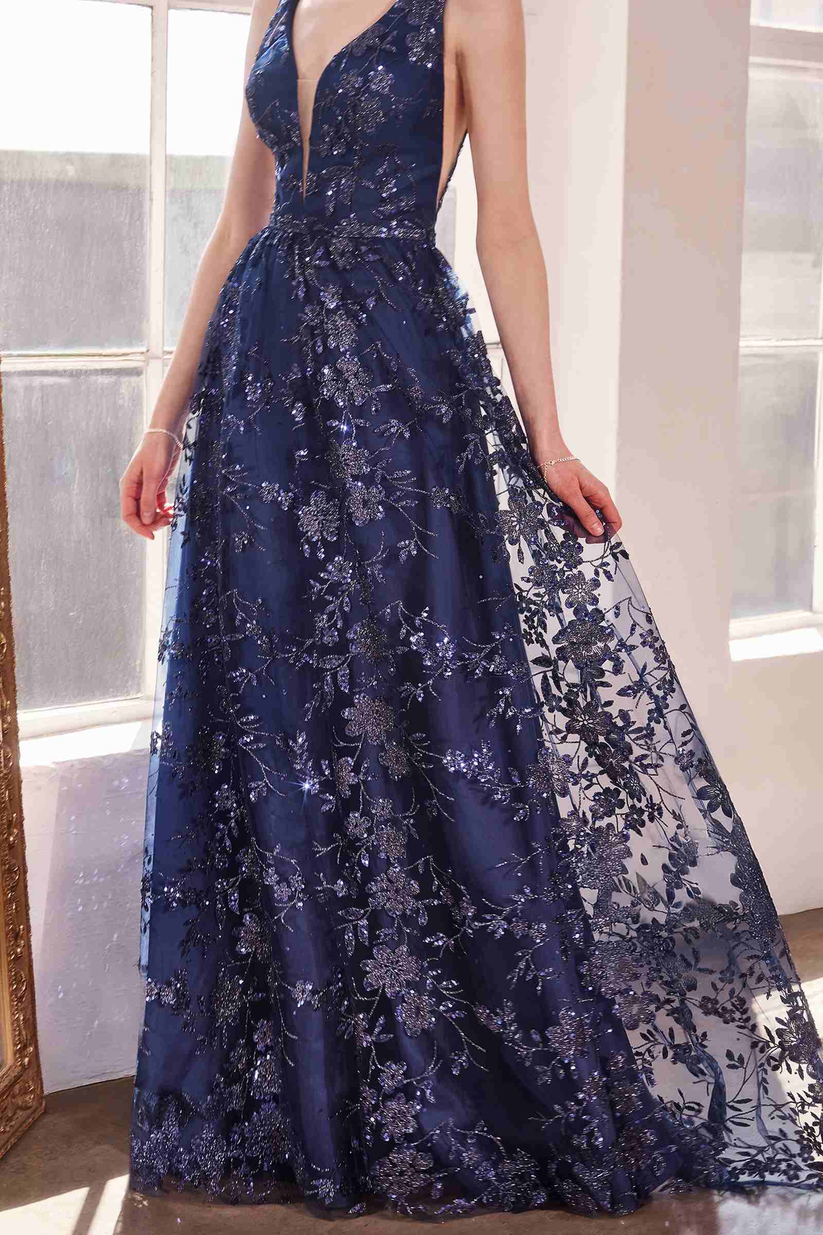 Navy long A-line gown, sleeveless V-neck with all-over glitter floral lace pattern.