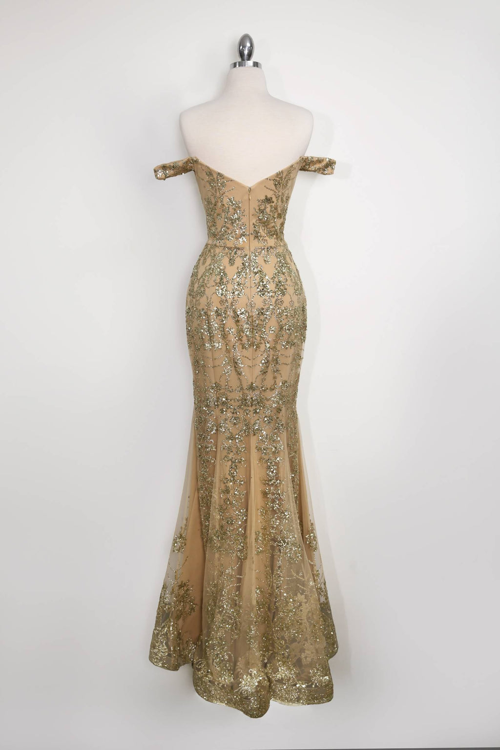 Gold sequin lace fitted gown on mannequin with mermaid silhouette