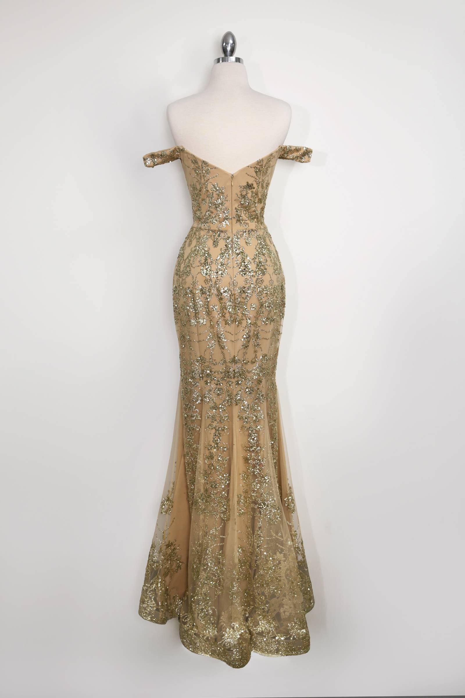 Gold sequin lace fitted gown on mannequin with mermaid silhouette