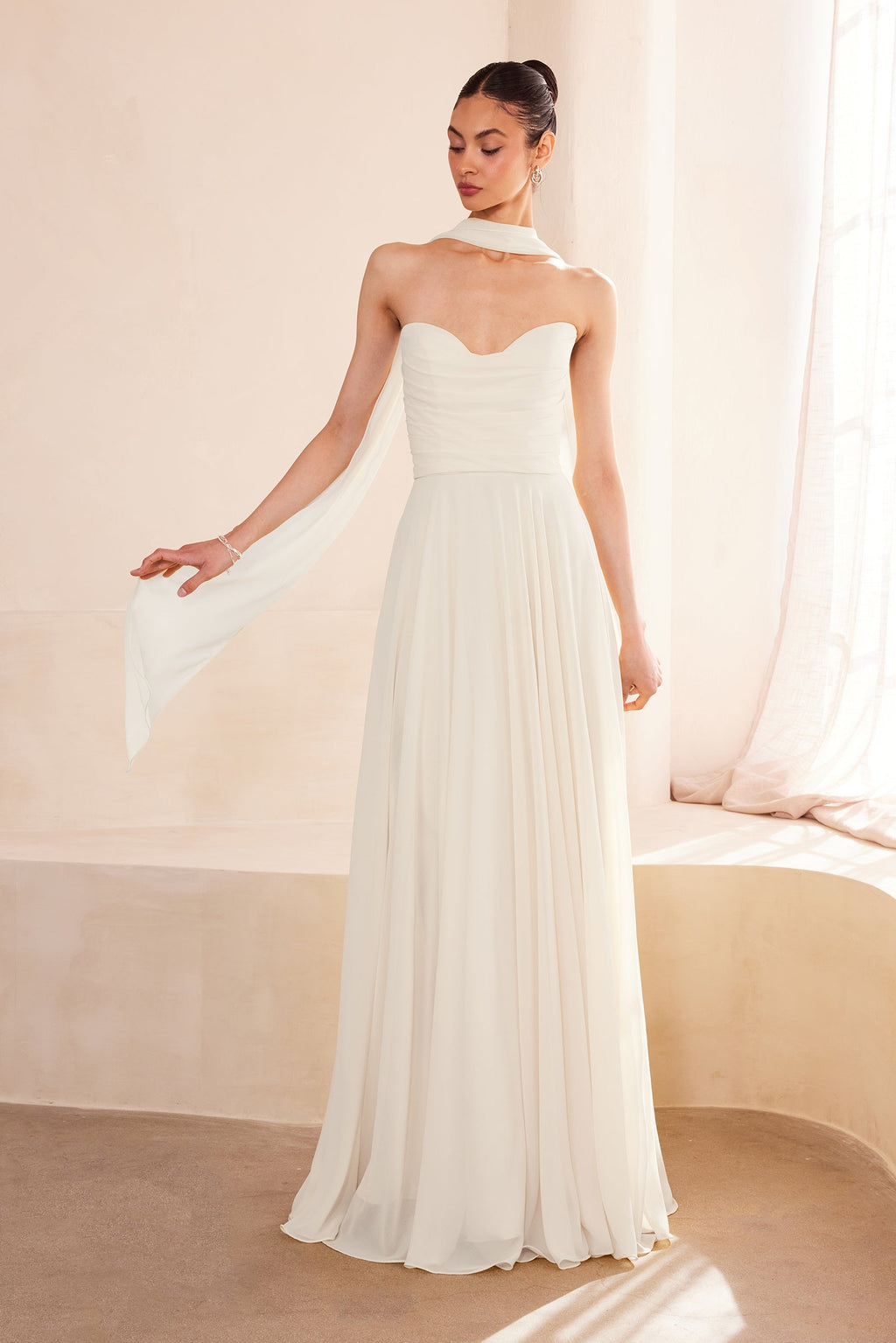 Off-white strapless A-line gown with sweetheart bodice and softly pleated skirt
