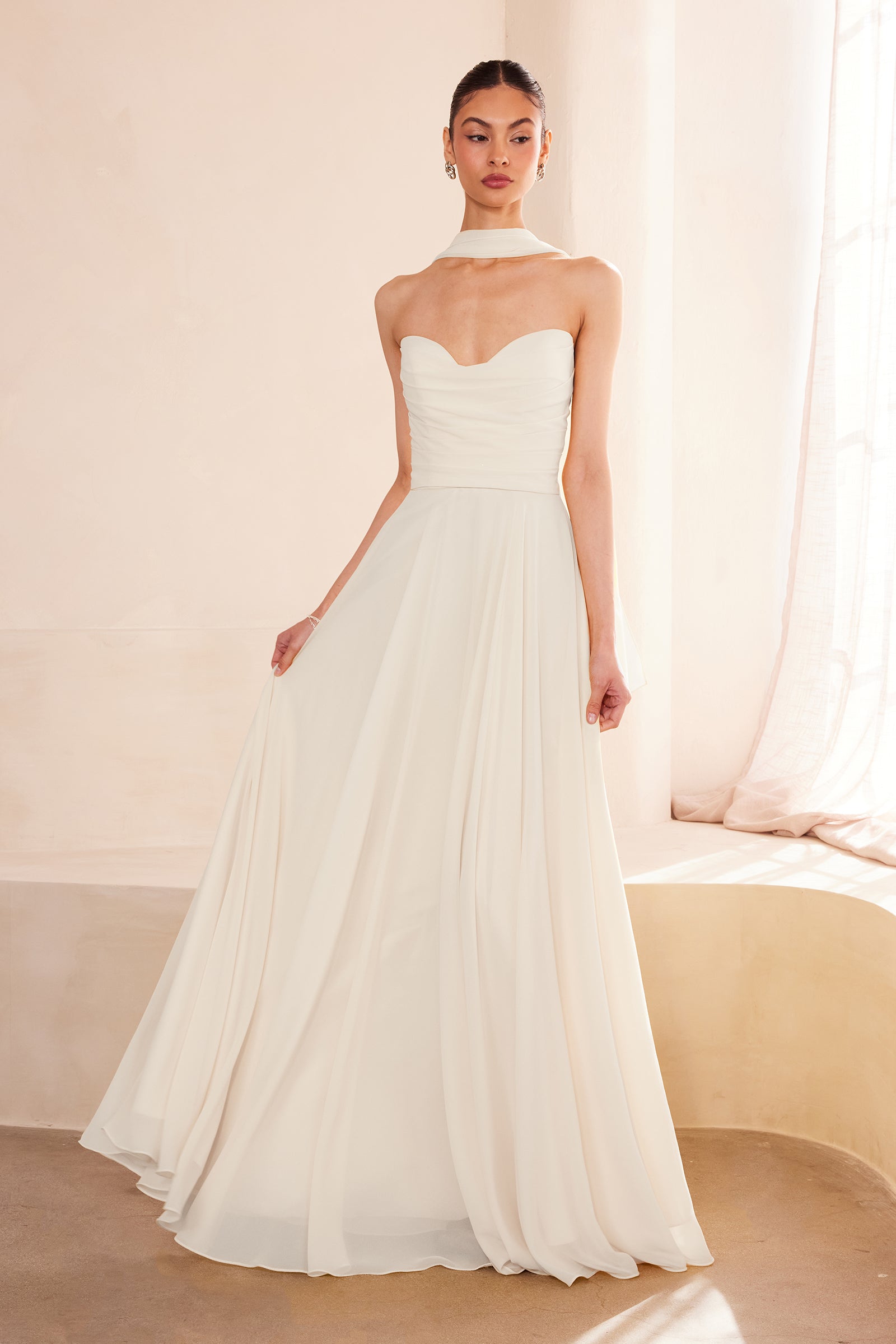 Off-white strapless A-line gown with sweetheart neckline and flowing full skirt