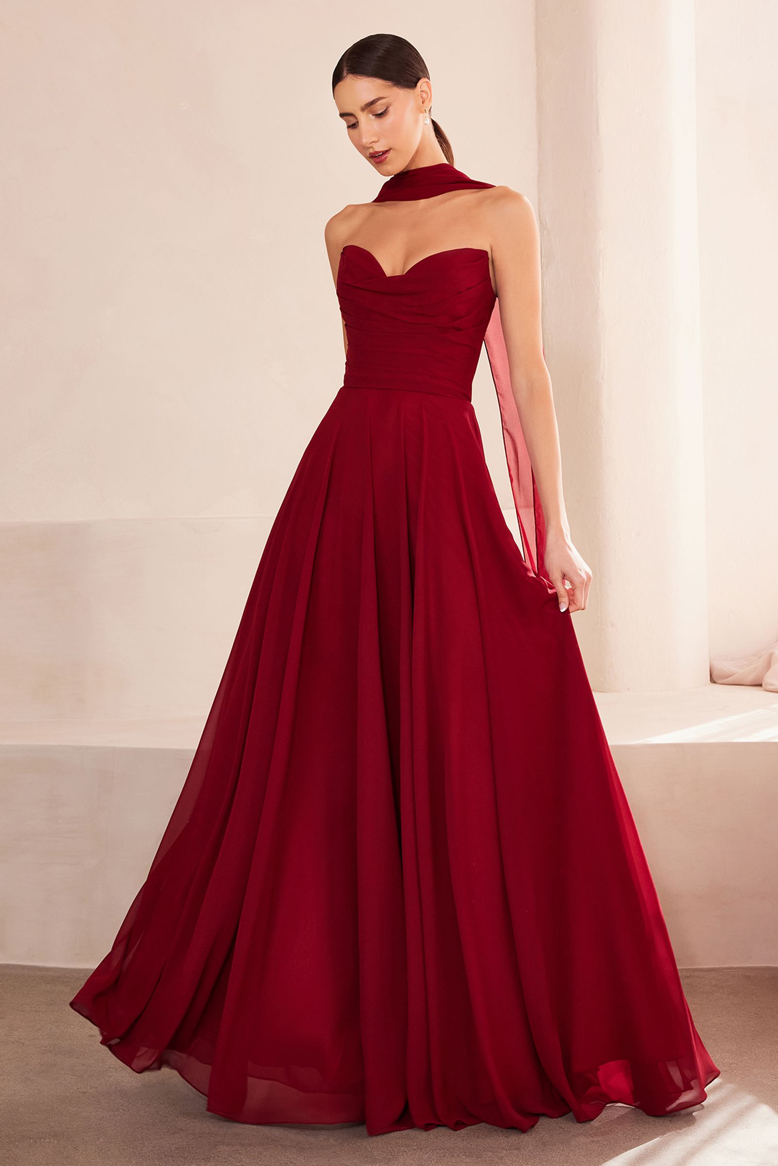 Strapless A-line bridesmaid dress in burgundy with fitted bodice and pleated skirt