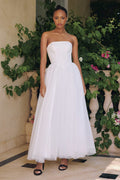 Off-white strapless A-line bridal gown with layered tulle skirt, cinched bodice