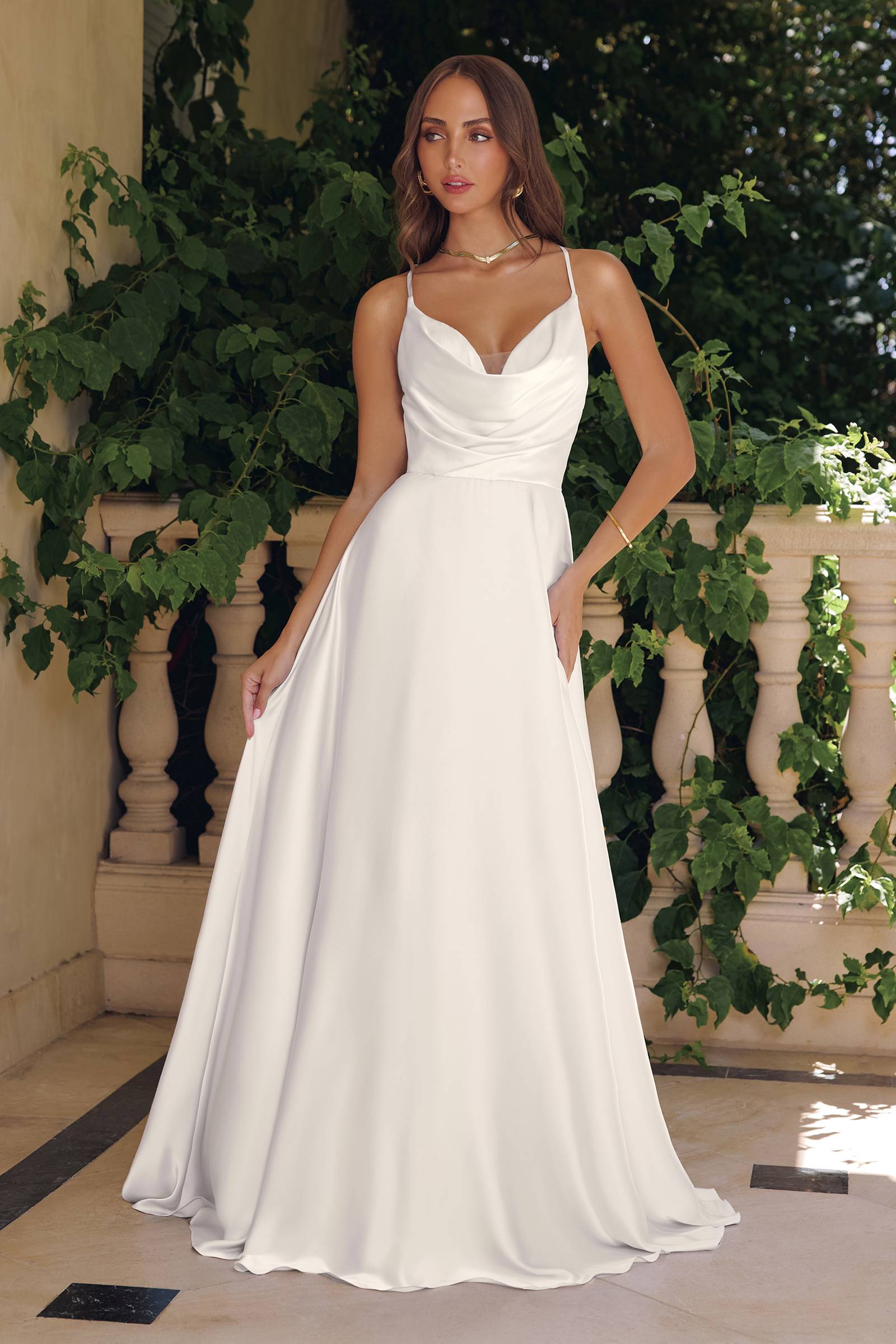 Off-white A-line wedding dress with spaghetti straps and V-neck front