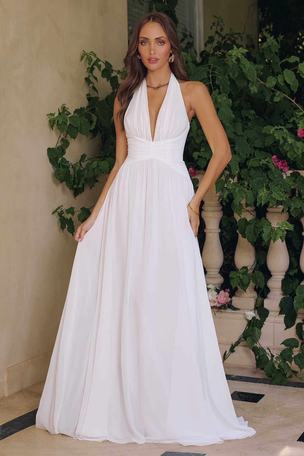 Off-white chiffon A-line evening gown with halter V-neck and draped waist