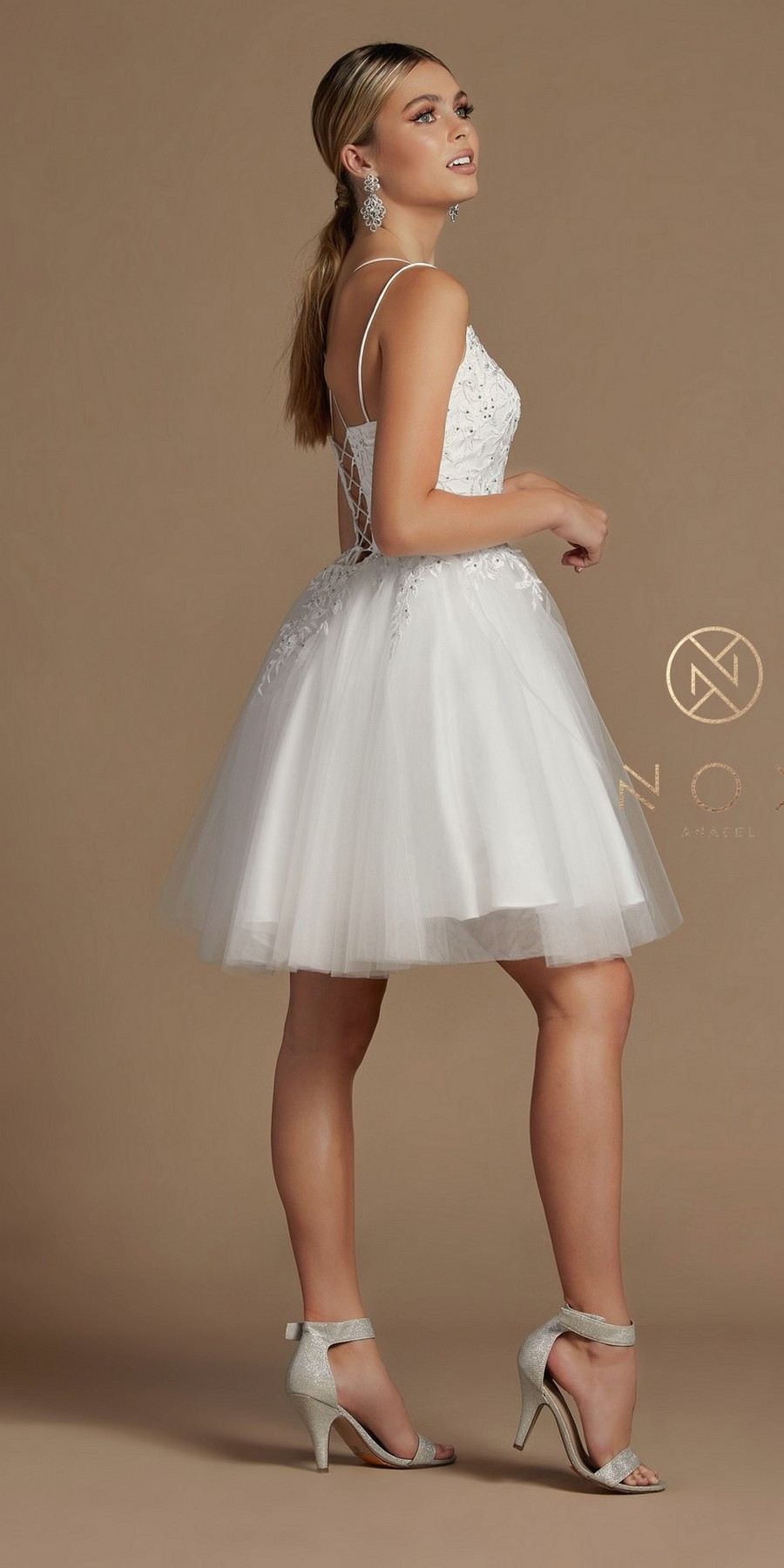 White corset-back baby doll dress with lace bodice, thin straps, tulle skirt