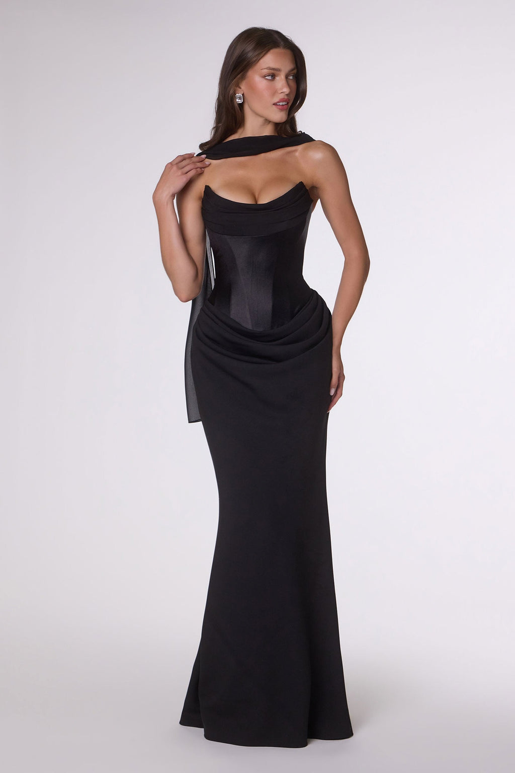 Strapless fitted column gown in black with cowl neckline and draped waist