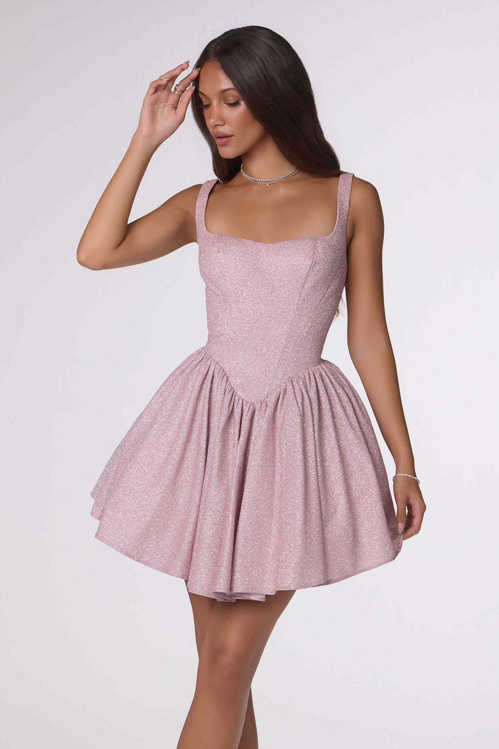 Light pink fitted bodice mini dress with spaghetti straps and tiered ruffle skirt