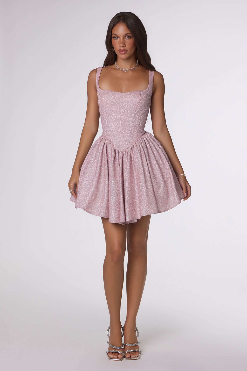 Light pink sleeveless mini dress with fitted bodice and tiered ruffle skirt