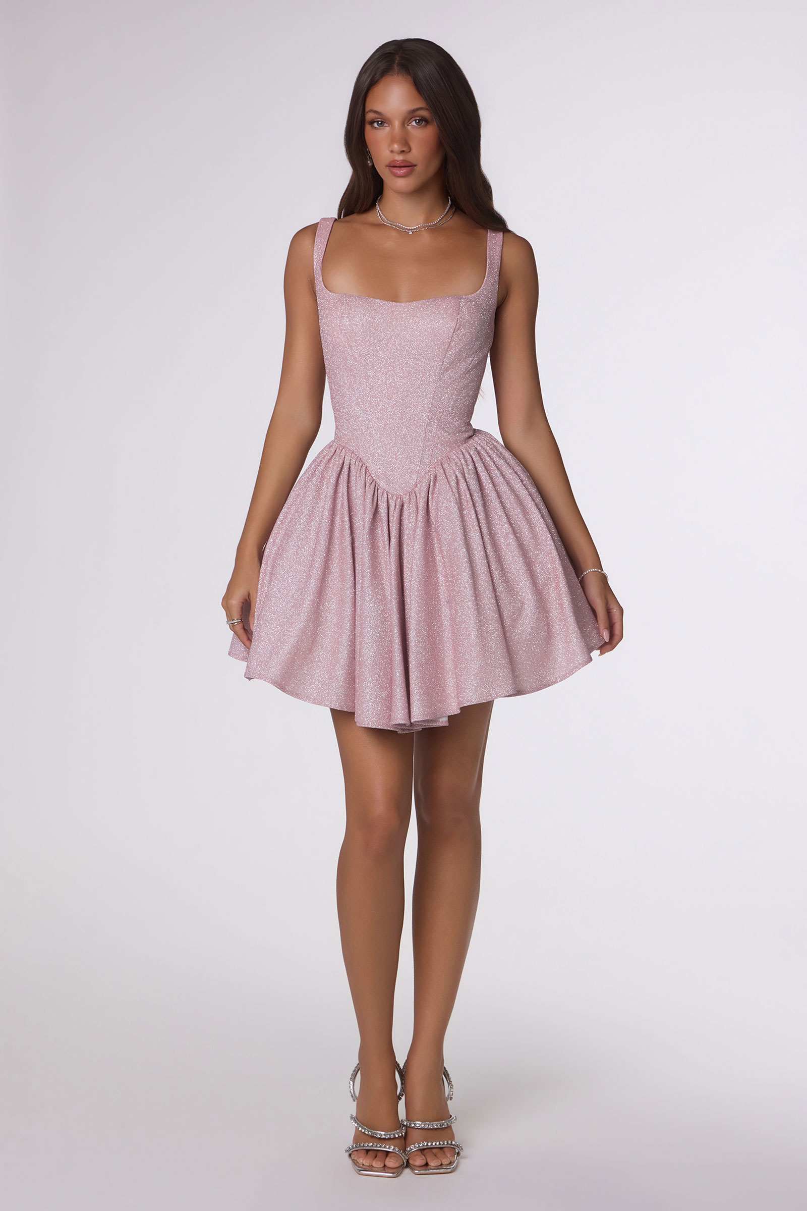 Light pink sleeveless mini dress with fitted bodice and tiered ruffle skirt