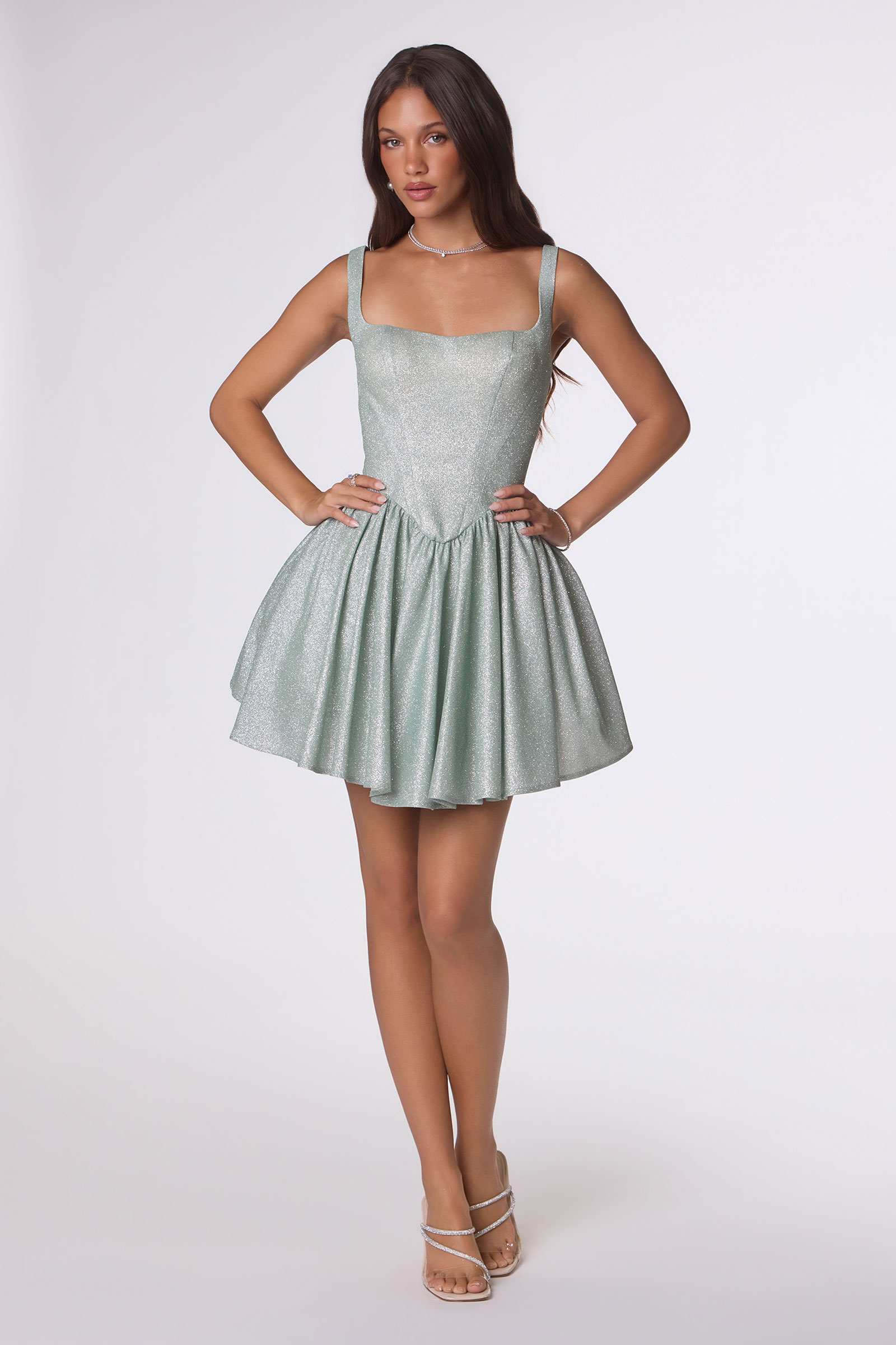 Sage green fitted bodice mini dress with spaghetti straps and tiered ruffle skirt