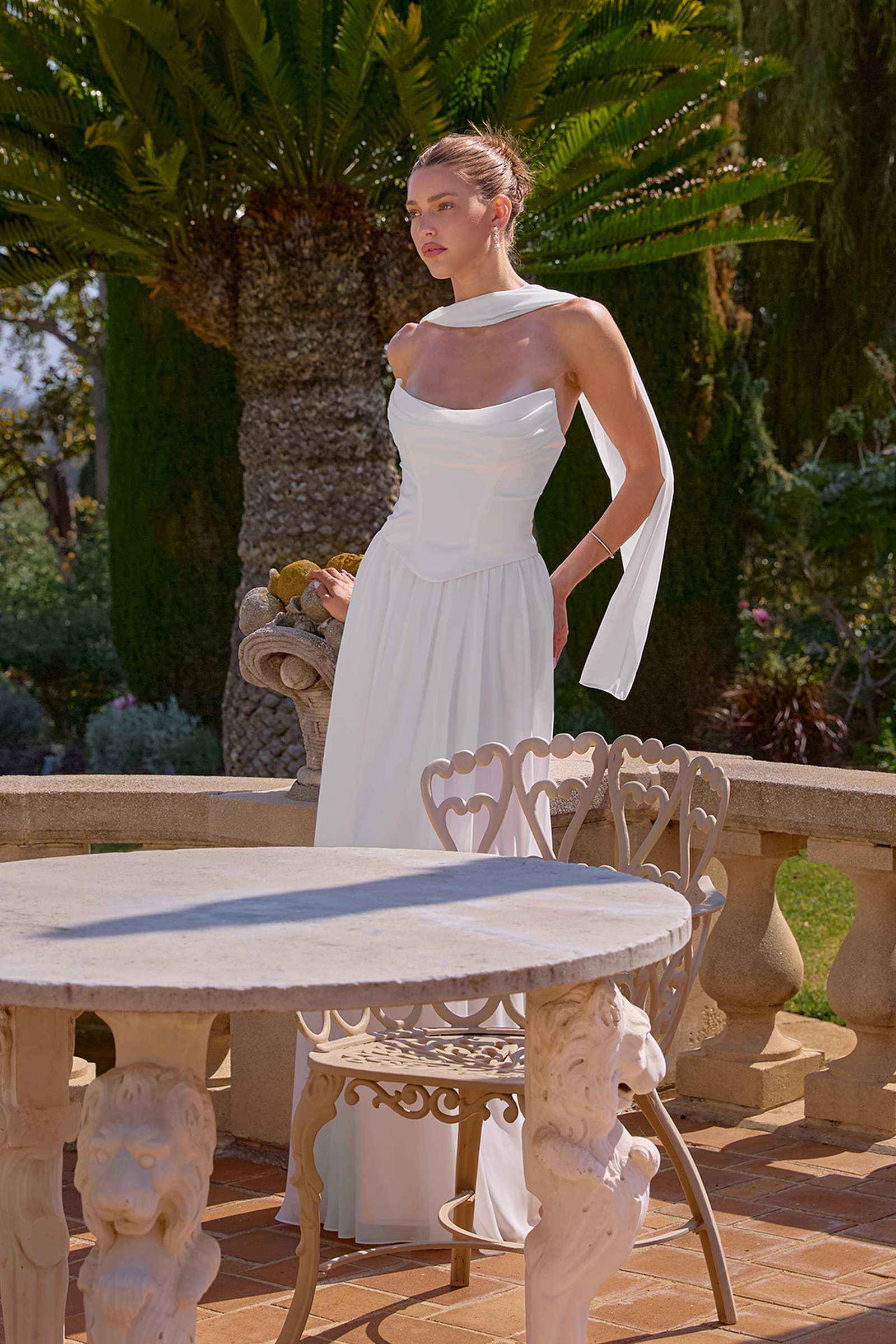 Off-white strapless chiffon A-line evening gown with fitted waist and pleated skirt