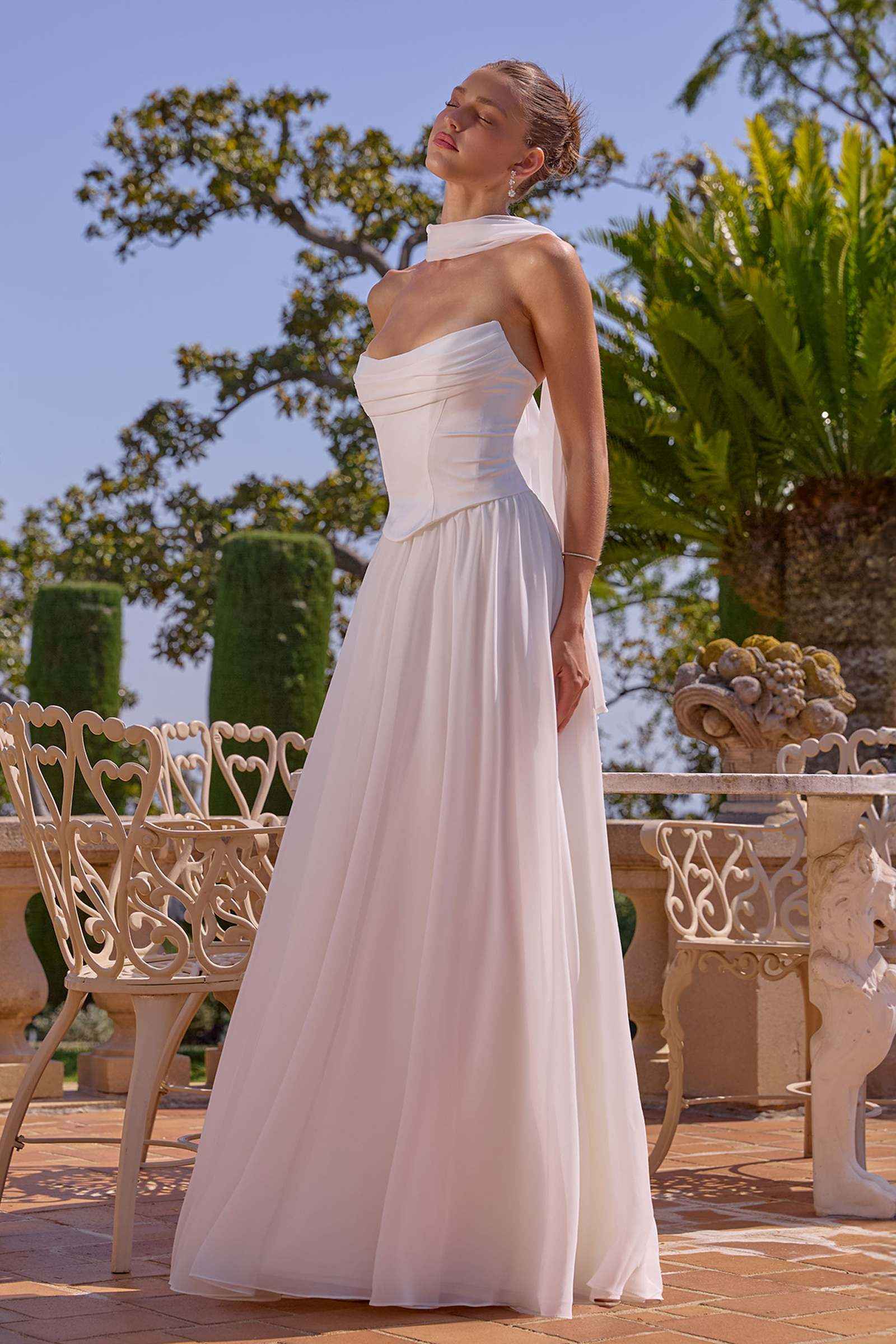 Off-white strapless chiffon A-line evening gown with empire waist and long skirt
