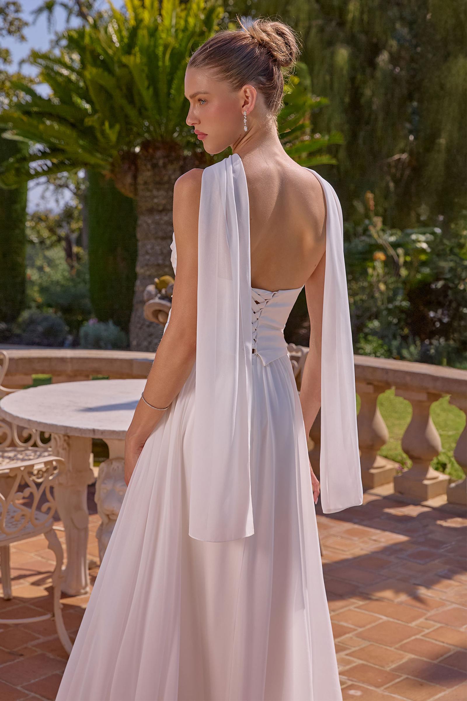 Off-white strapless A-line evening gown with open back drape and tie