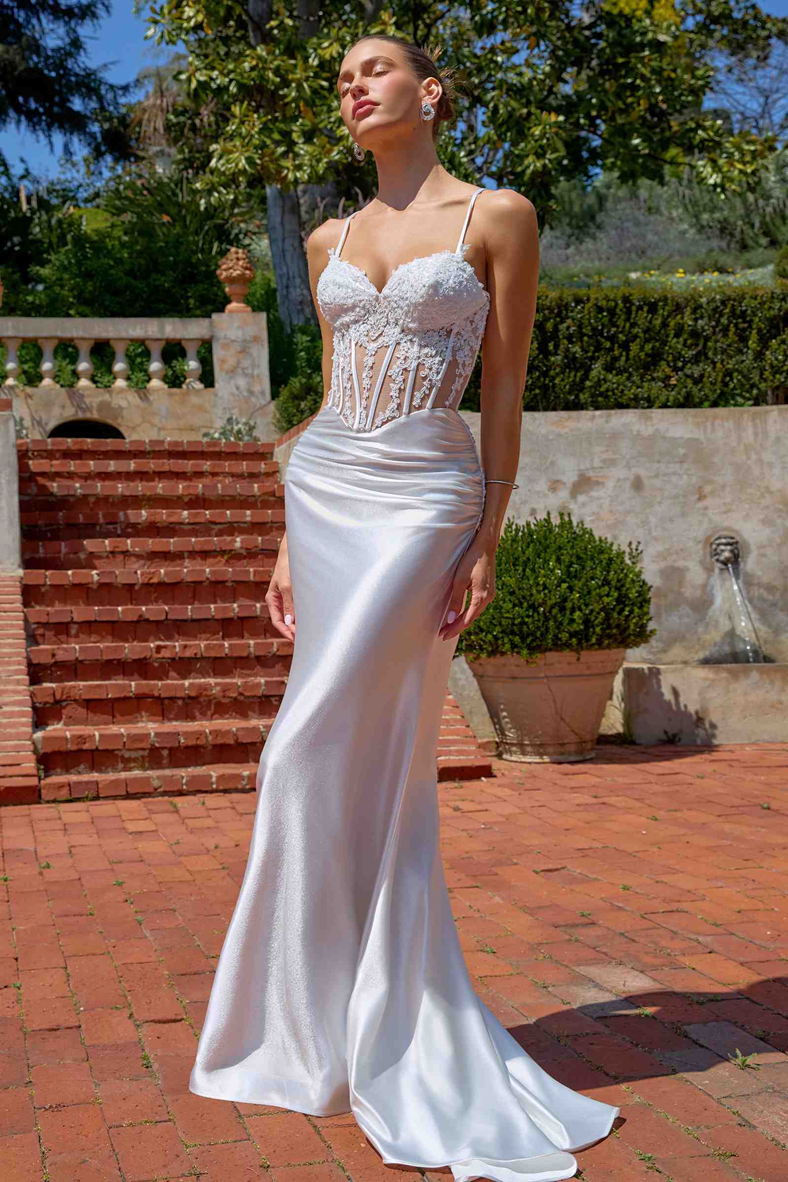 Off-white fitted mermaid evening gown with sheer corset bodice and spaghetti straps
