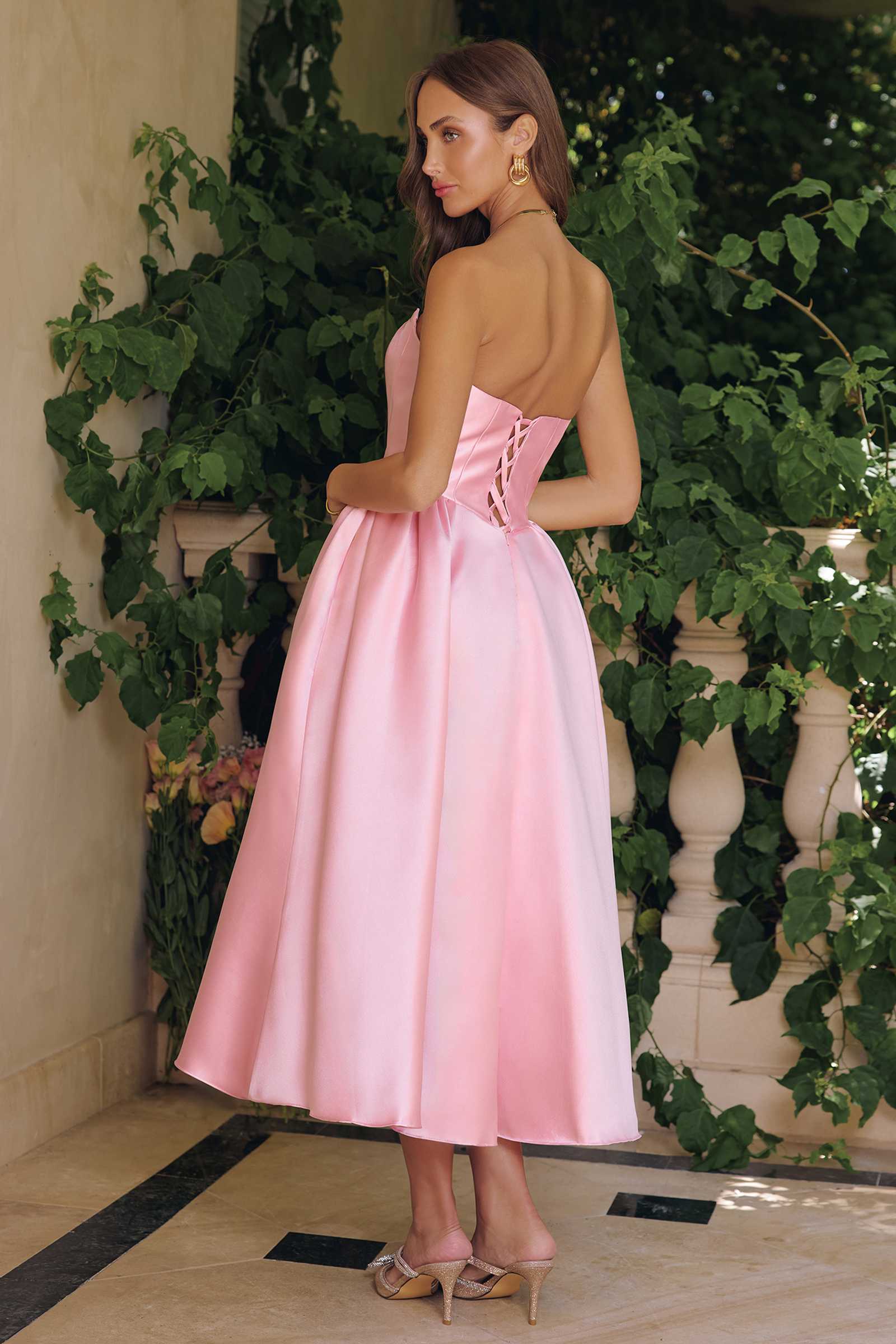 Pink strapless midi gown with low back and flared, gathered skirt