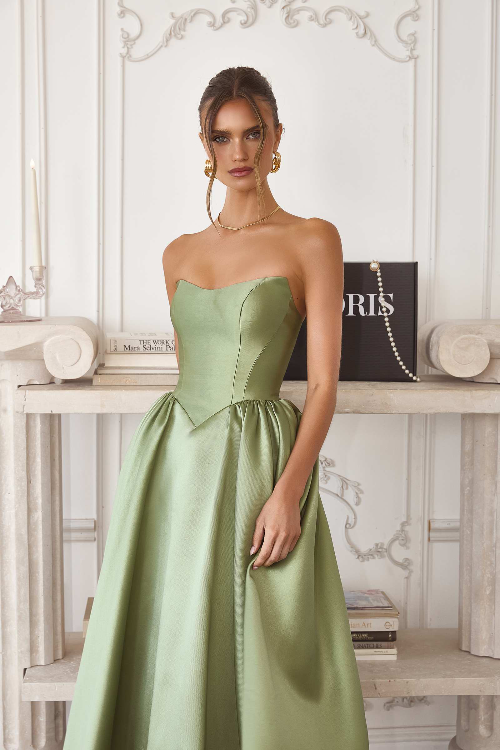 Sage green strapless midi gown with structured bodice and flared skirt
