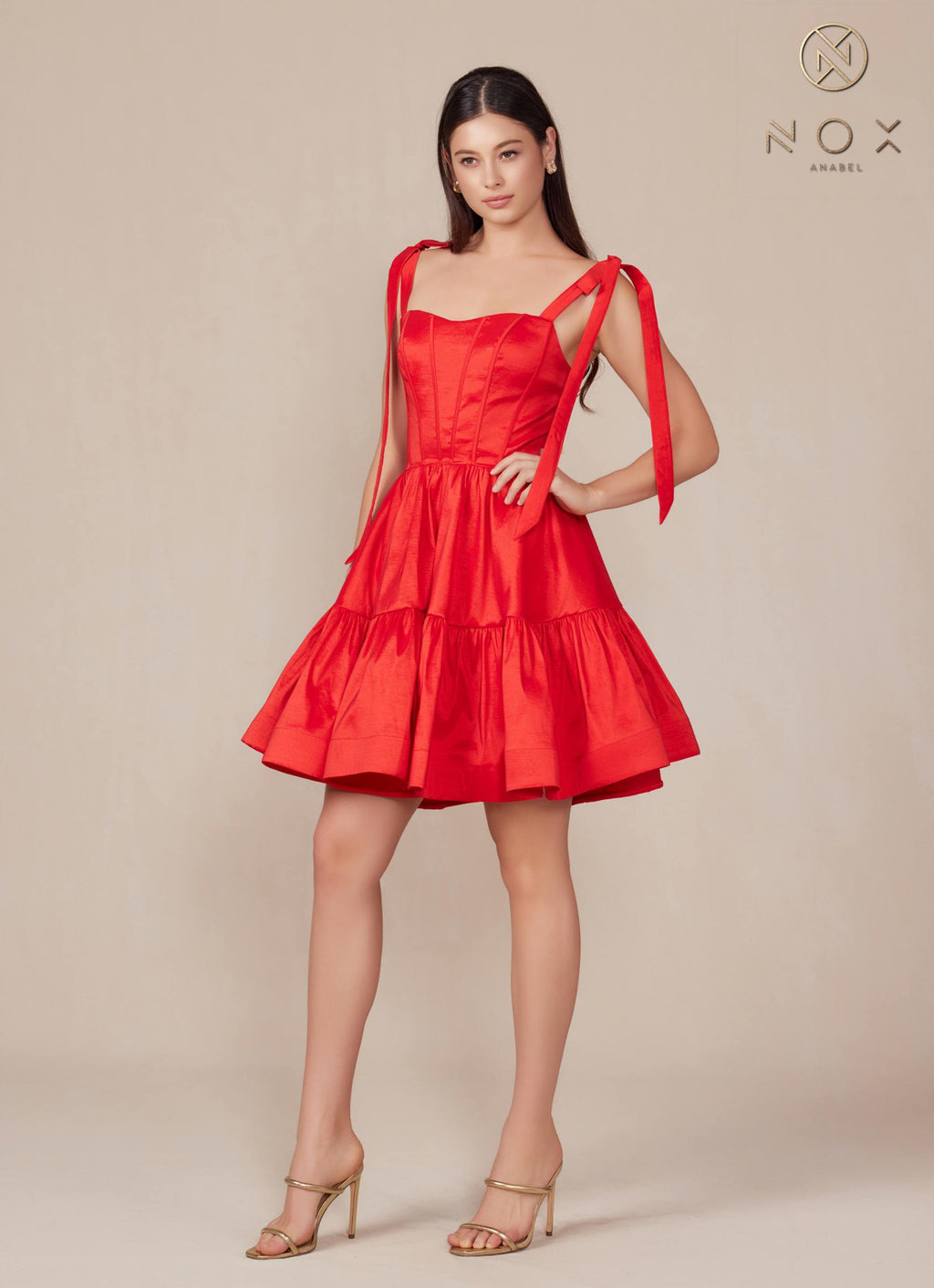 Red A-line mini dress with semi-sweetheart neckline and ribbon straps, tiered skirt