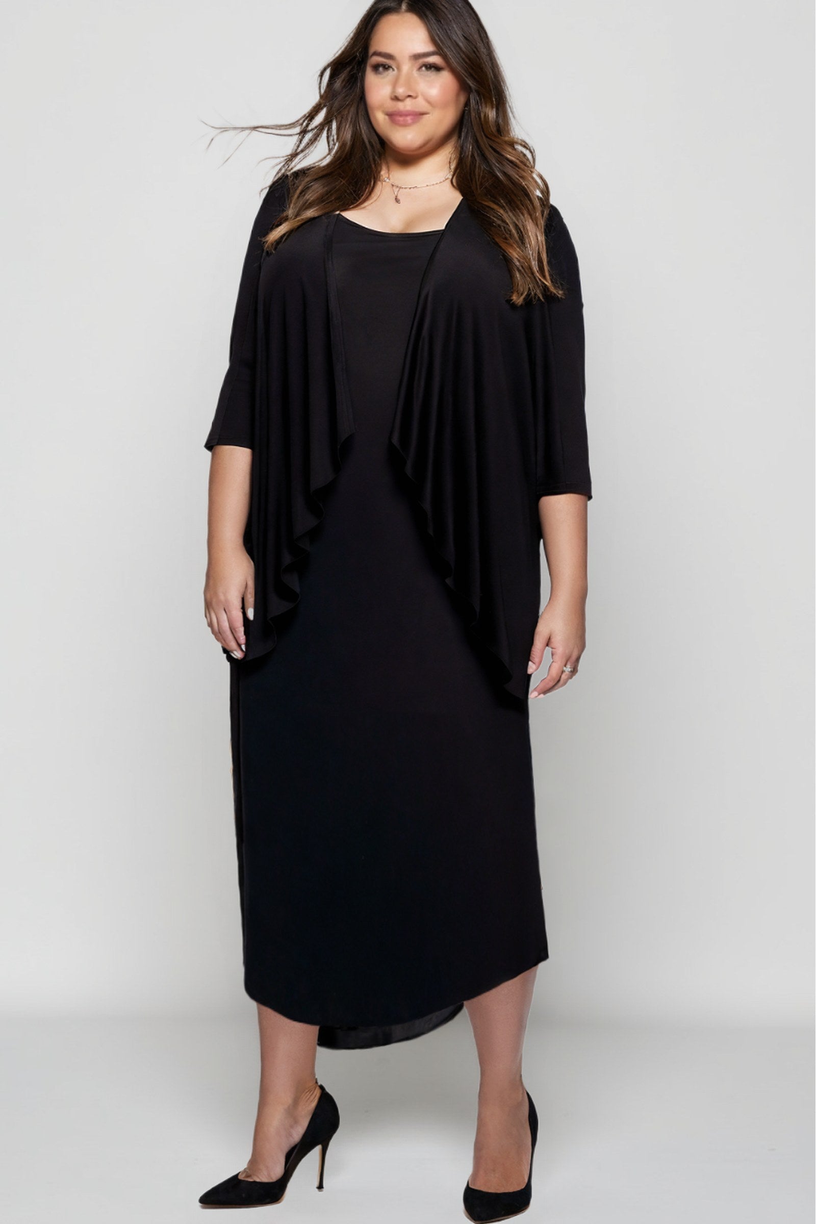 Black evening gown with draped capelet overlay, three-quarter sleeves, and fitted skirt
