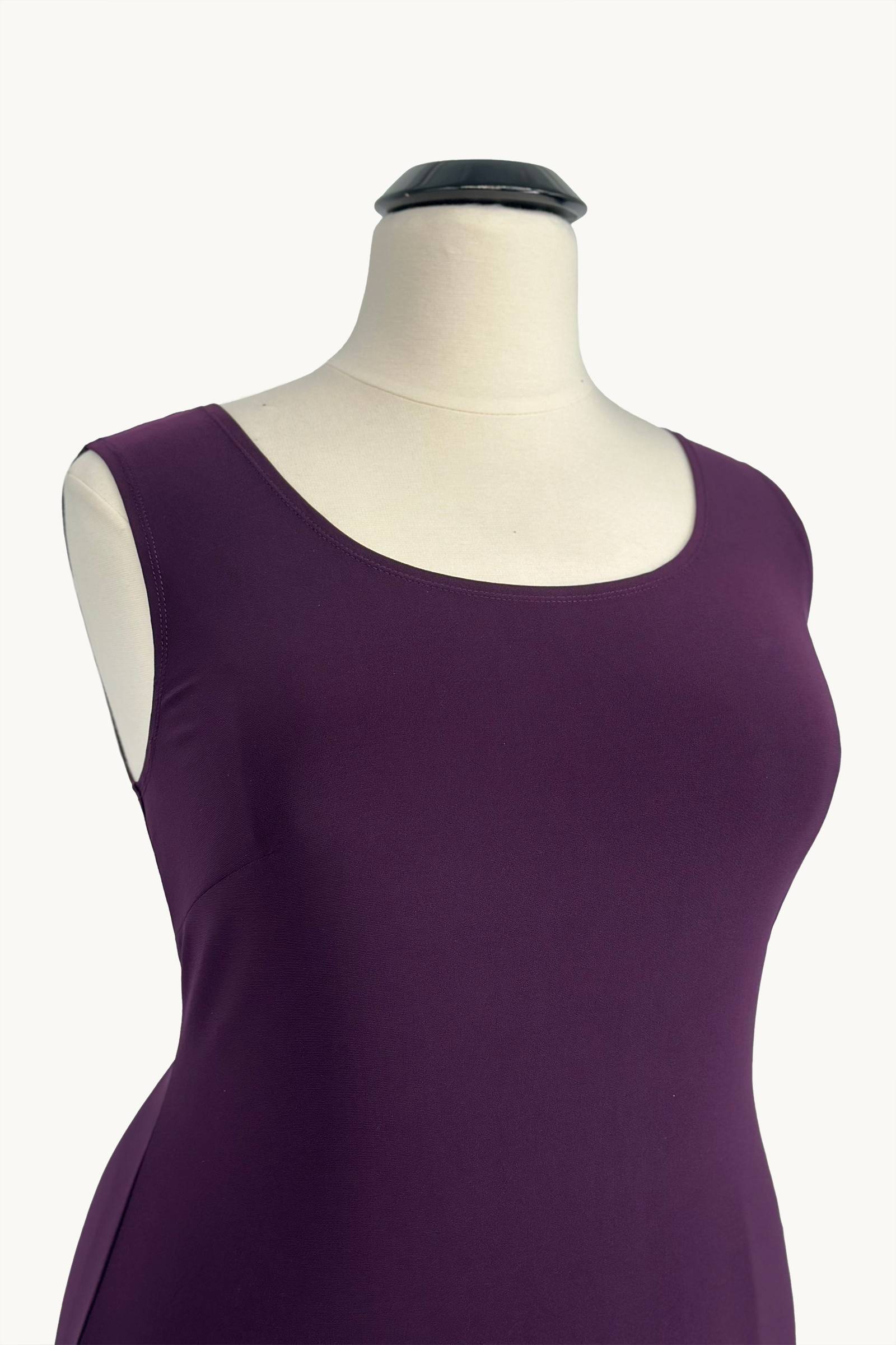 Eggplant purple sleeveless dress close-up with square neckline and draped front panel