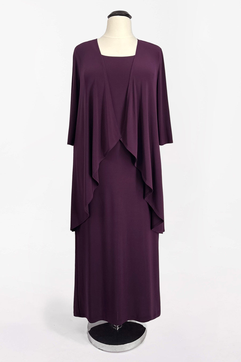Eggplant purple semi-formal gown set on hanger: cape overlay over fitted midi dress