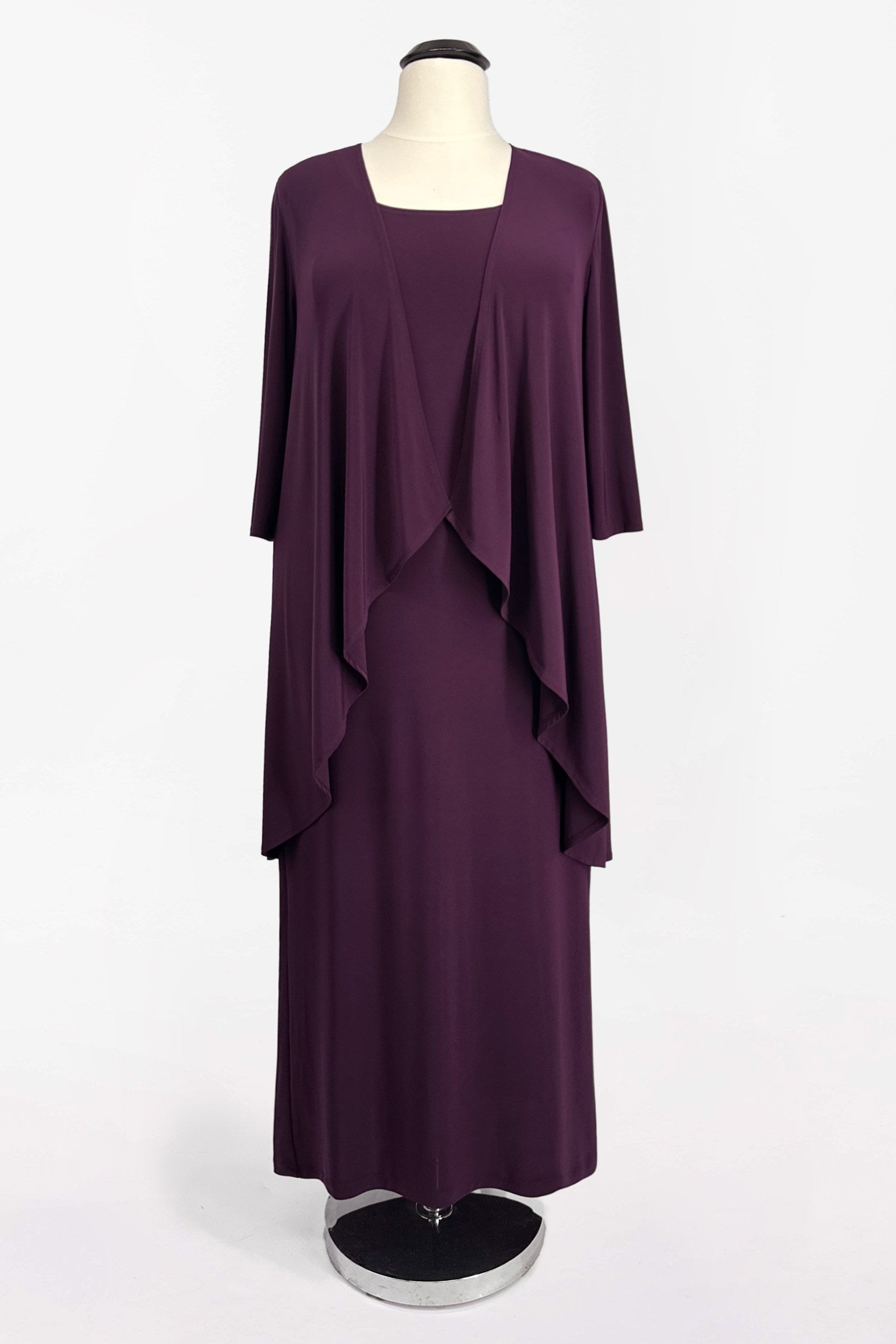 Eggplant purple semi-formal gown set on hanger: cape overlay over fitted midi dress