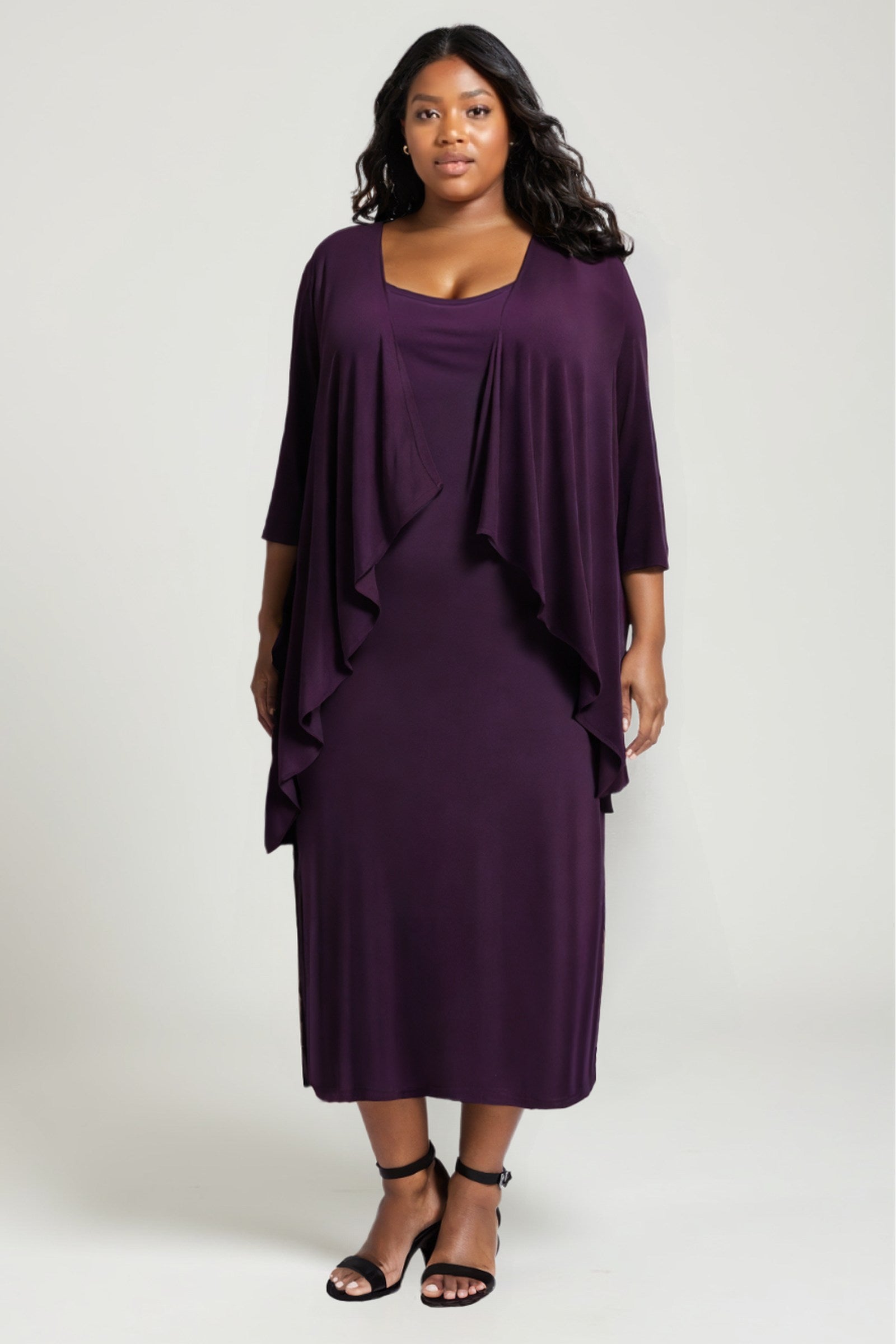 Eggplant purple semi-formal gown set with draped overlay cape over a fitted midi dress