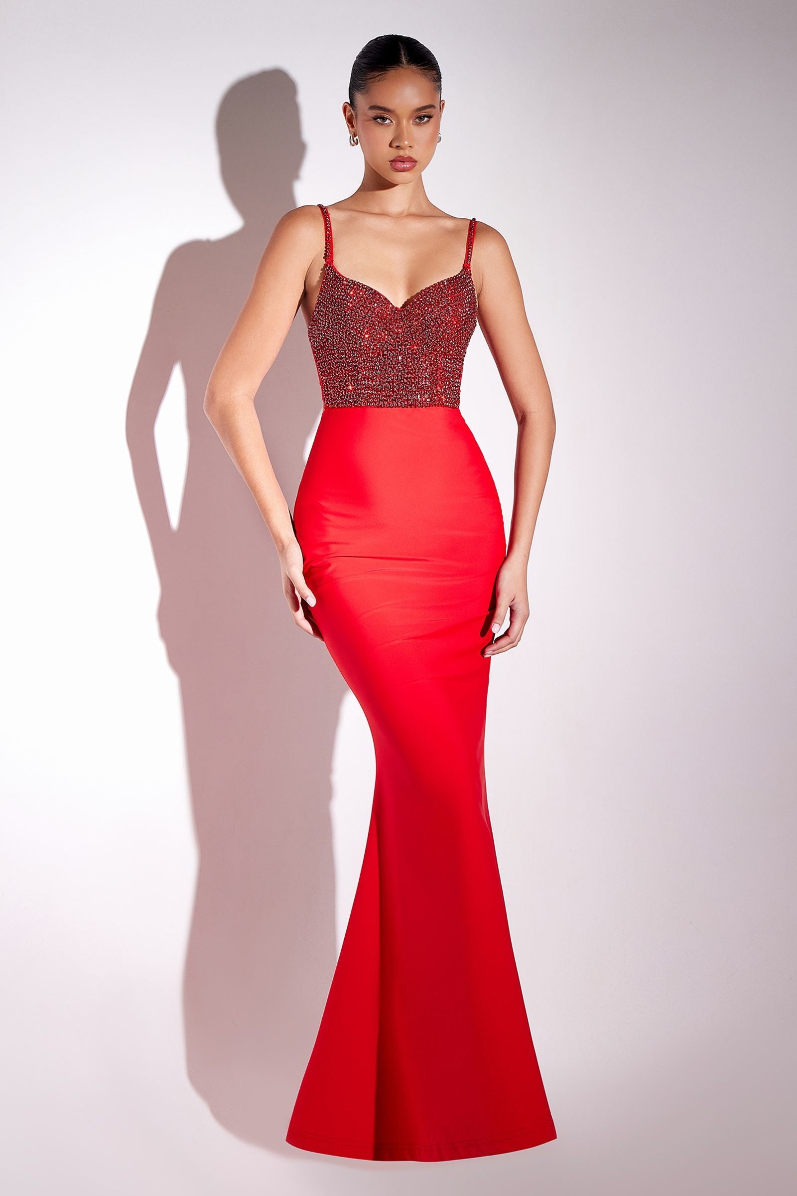 Red long fitted mermaid gown with embellished V-neck bodice and thin straps