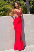 Red fitted formal gown with embellished bodice, V-neck, and thin shoulder straps