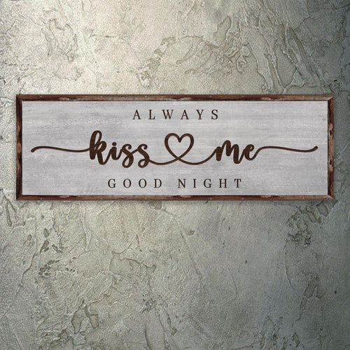 Wood-framed wall sign on gray canvas with “Always kiss me good night” lettering