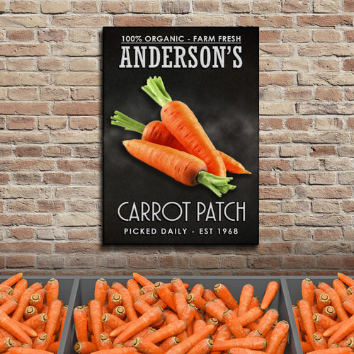 Carrot patch wall sign on brick with orange carrot illustration and green tops