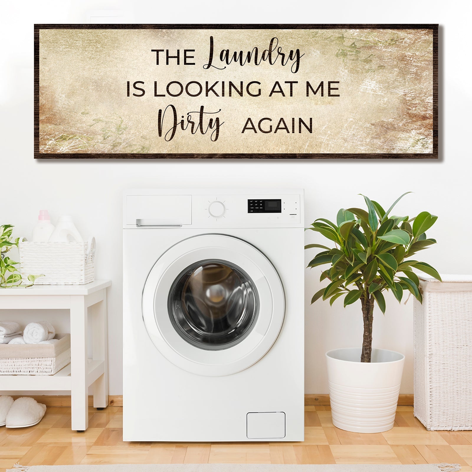 Laundry wall sign with text "The Laundry is looking at me Dirty again" on distressed beige