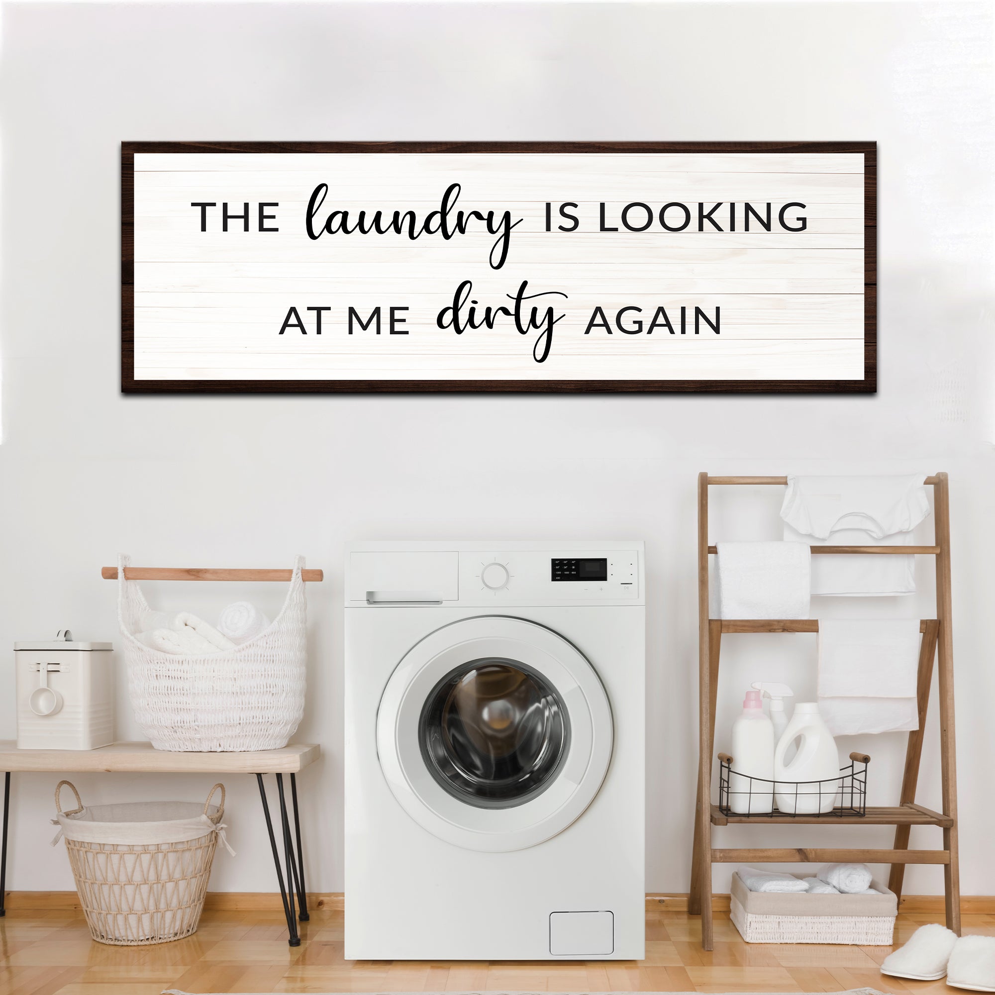 Laundry wall sign above laundry area: 'The laundry is looking at me dirty again'