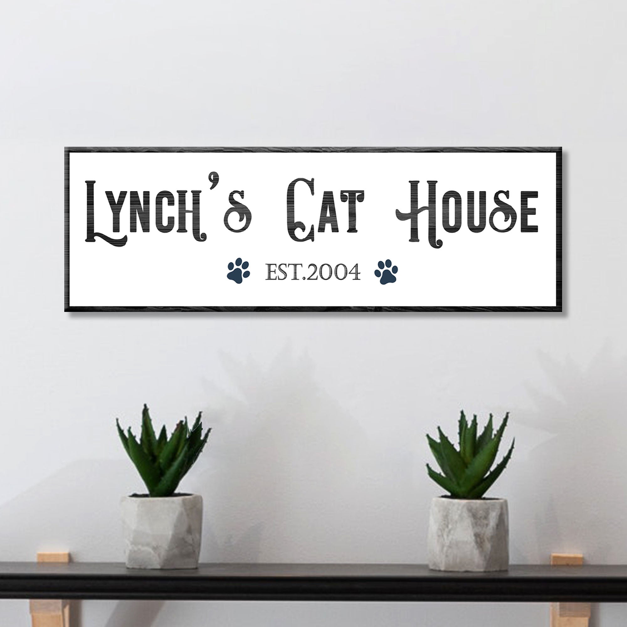 Framed canvas sign with "Lynch's Cat House" text, paw icons, and EST.2004
