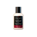 After-shave balm bottle with dark pump cap, beige liquid, sandalwood scent