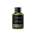 Unscented pre-shave oil bottle with green liquid, black label, and silver cap