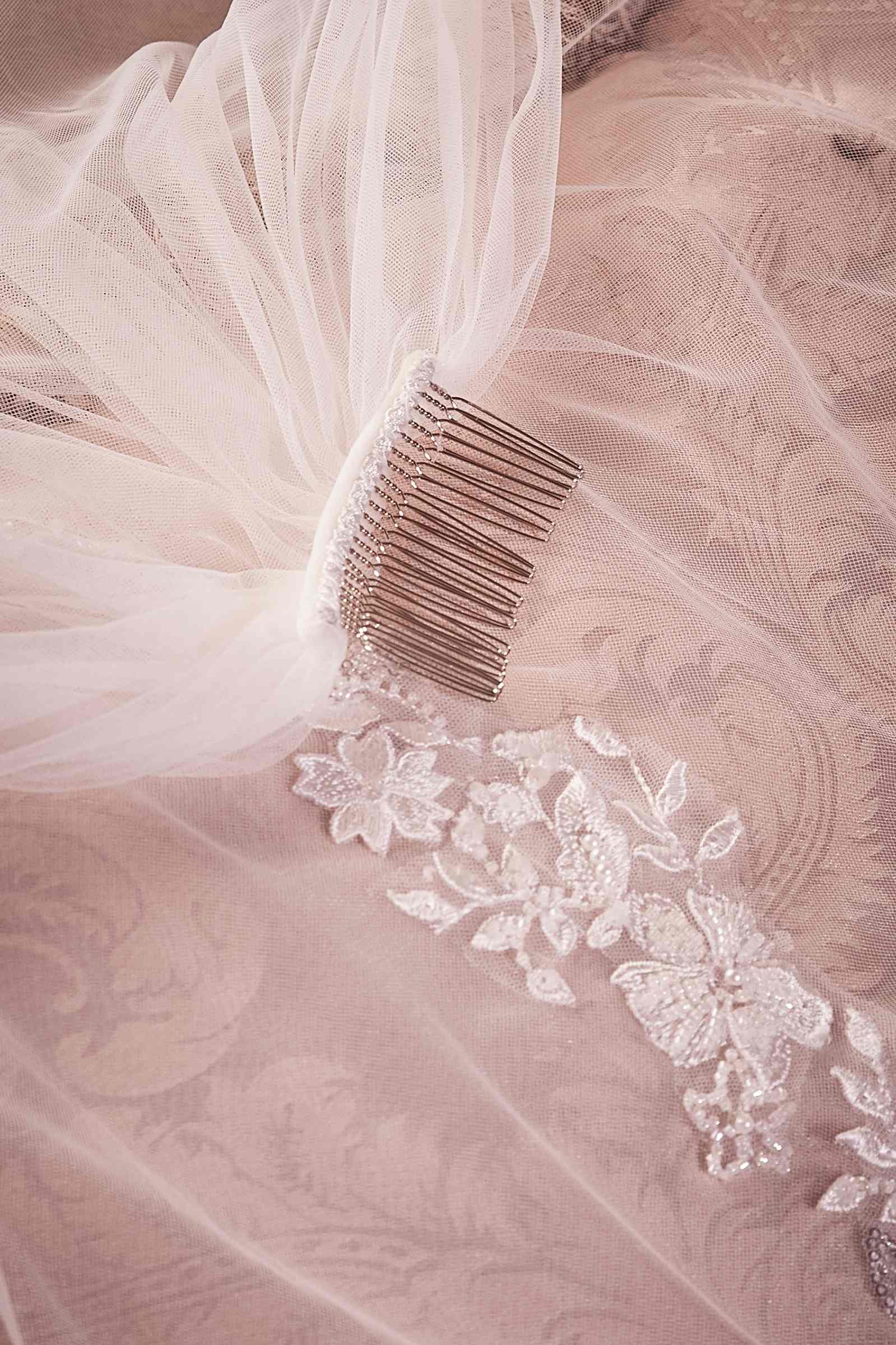 Off-white bridal veil with beaded lace detail and comb