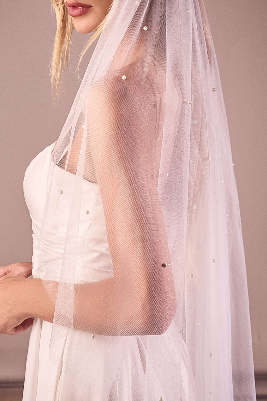 Off-white fingertip bridal veil close-up with sparkling bead accents