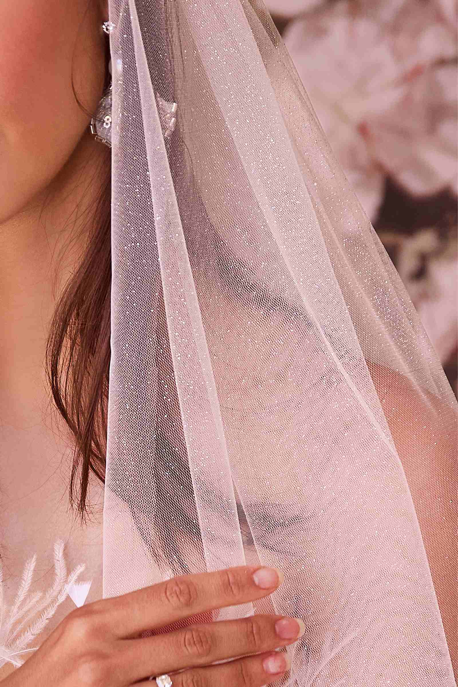 Off-white glittered sheer veil with fine sparkle detail along the edge