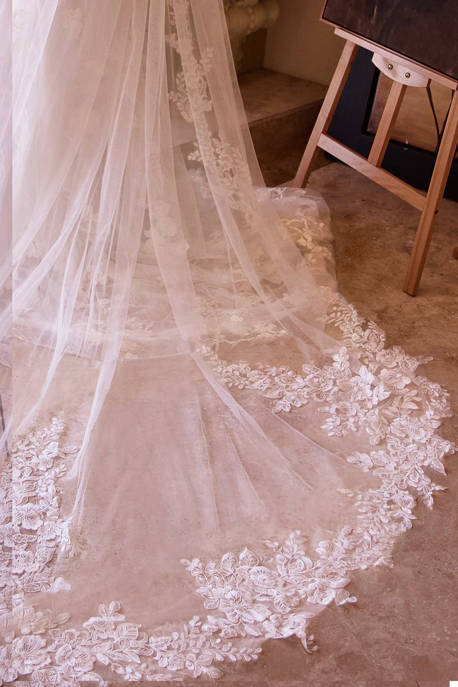 Off-white scalloped lace veil with layered sheer fabric and floral hem