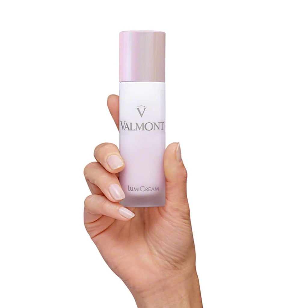 Valmont LumiCream 50 mL bottle held in a hand, pink cap