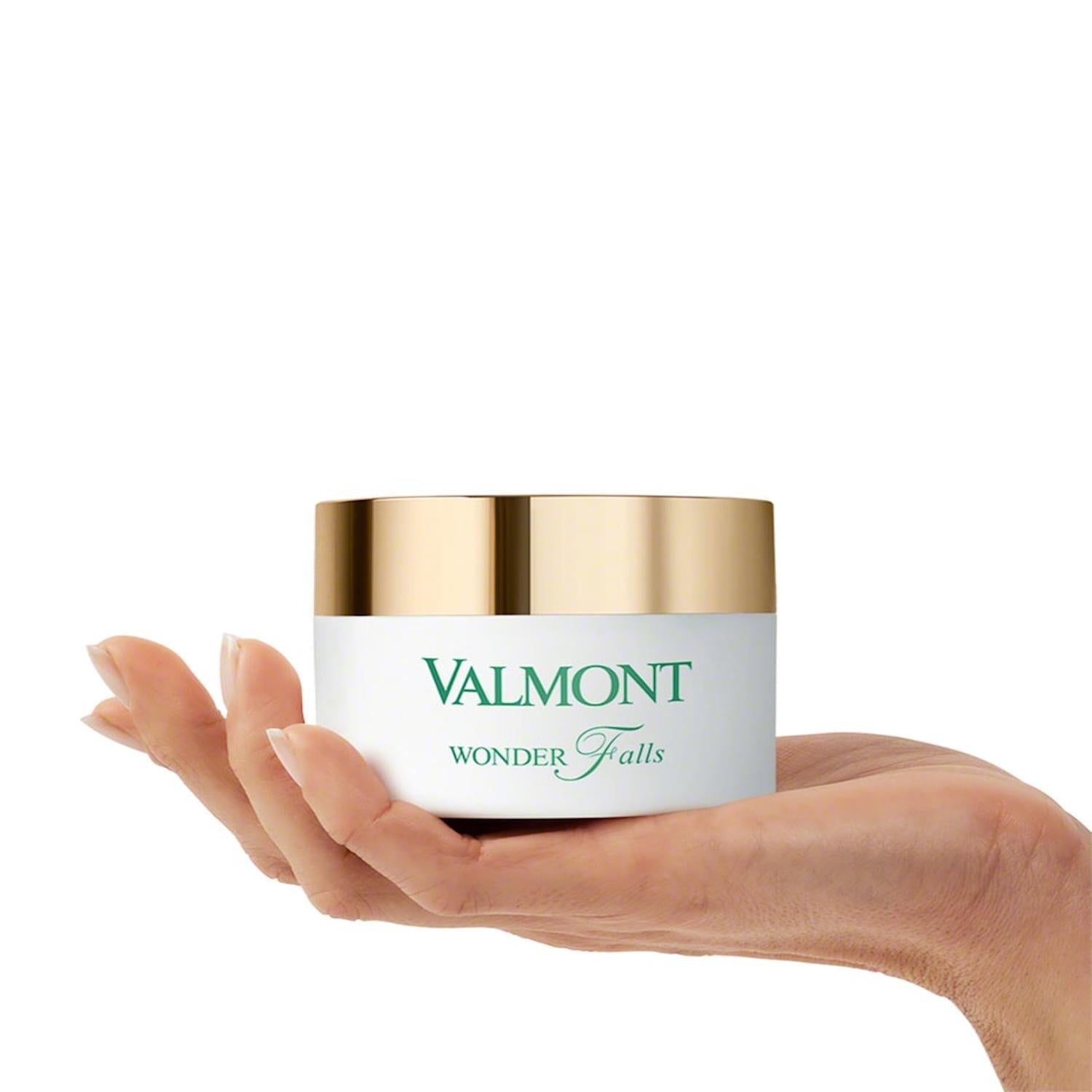 Valmont Wonder Falls cream jar held in hand with gold lid