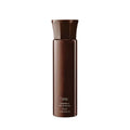 Oribe Volumista volumizing mist bottle, dark brown cylindrical container with cap