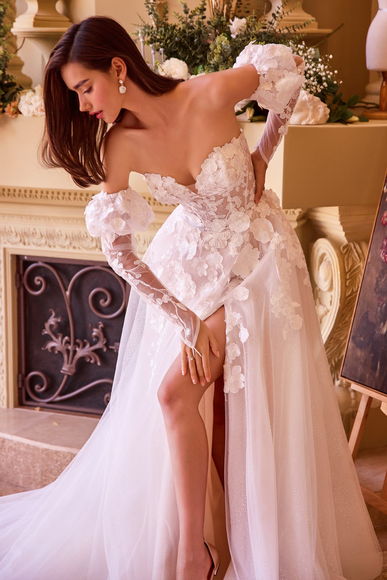 Off-white strapless wedding gown with 3D floral applique bodice and layered tulle skirt