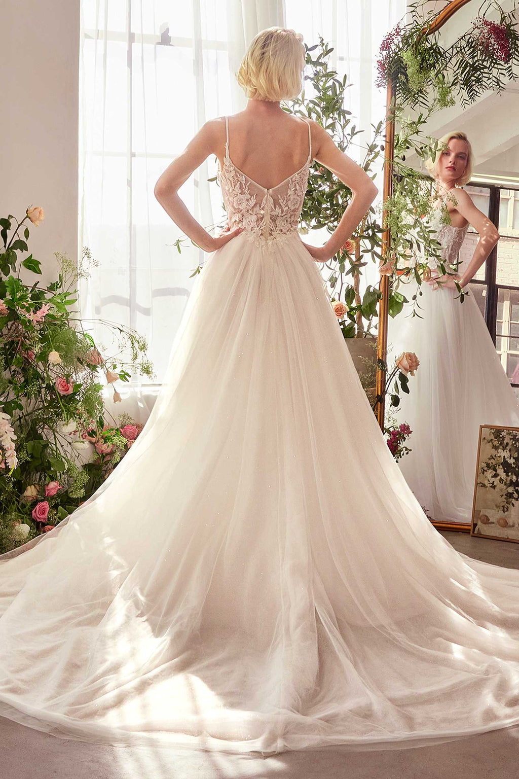 Off-white lace bridal gown with open back and flowing tulle ball skirt