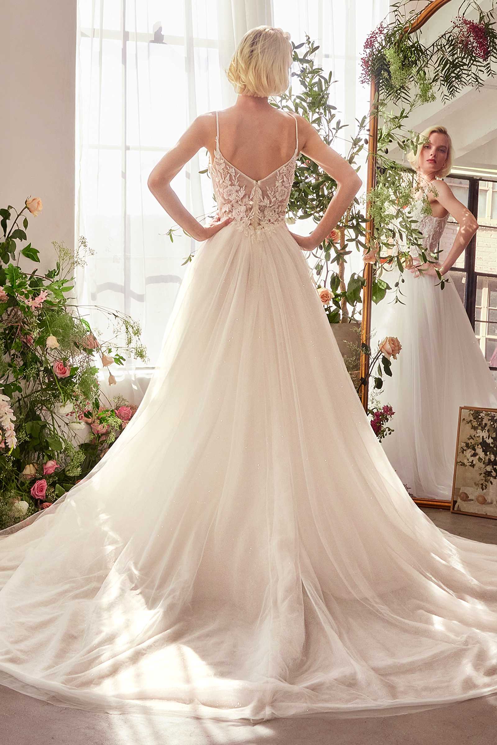 Off-white lace bridal gown with open back and flowing tulle ball skirt