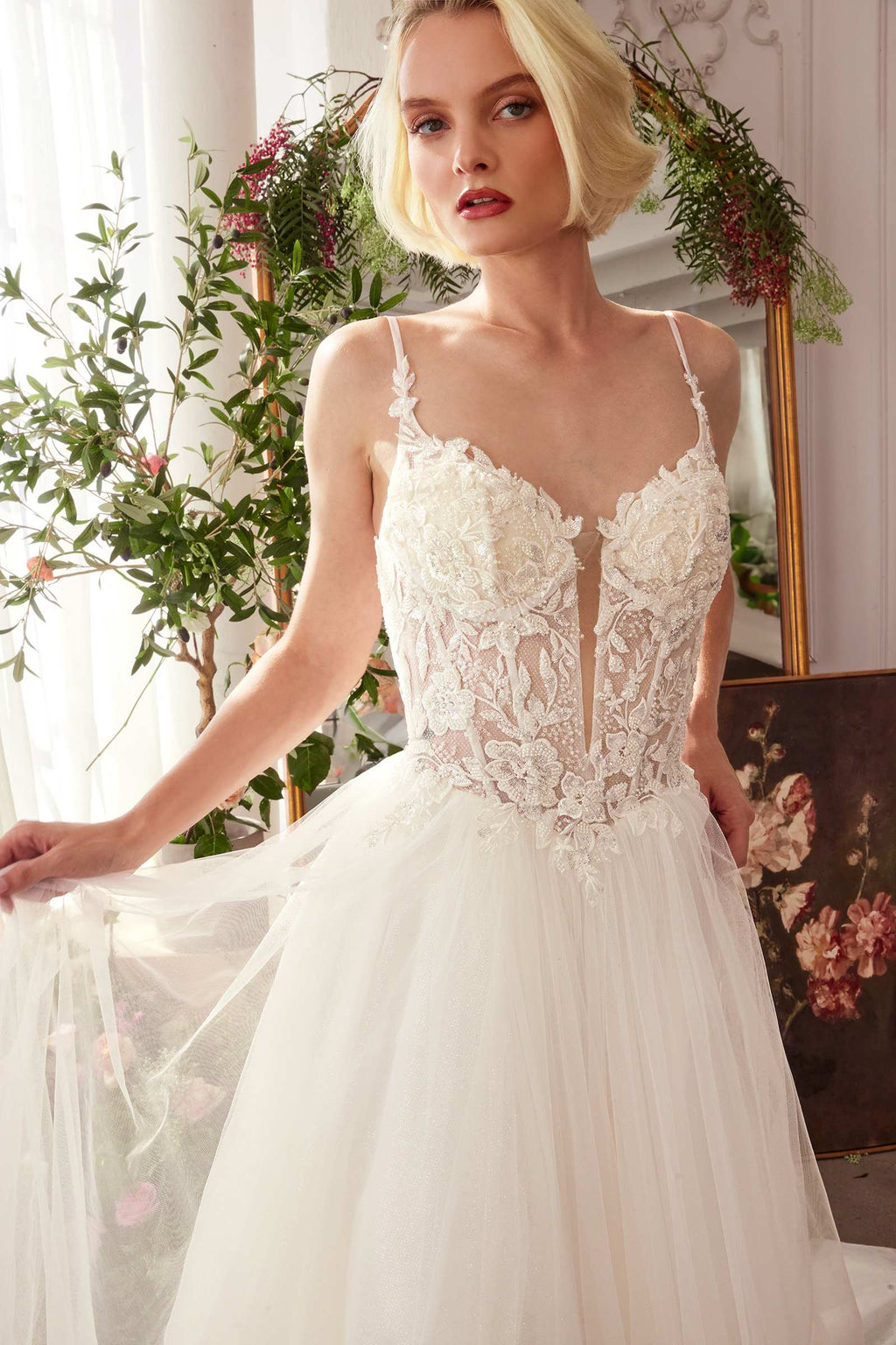 Off-white lace bodice bridal gown with spaghetti straps and layered tulle skirt