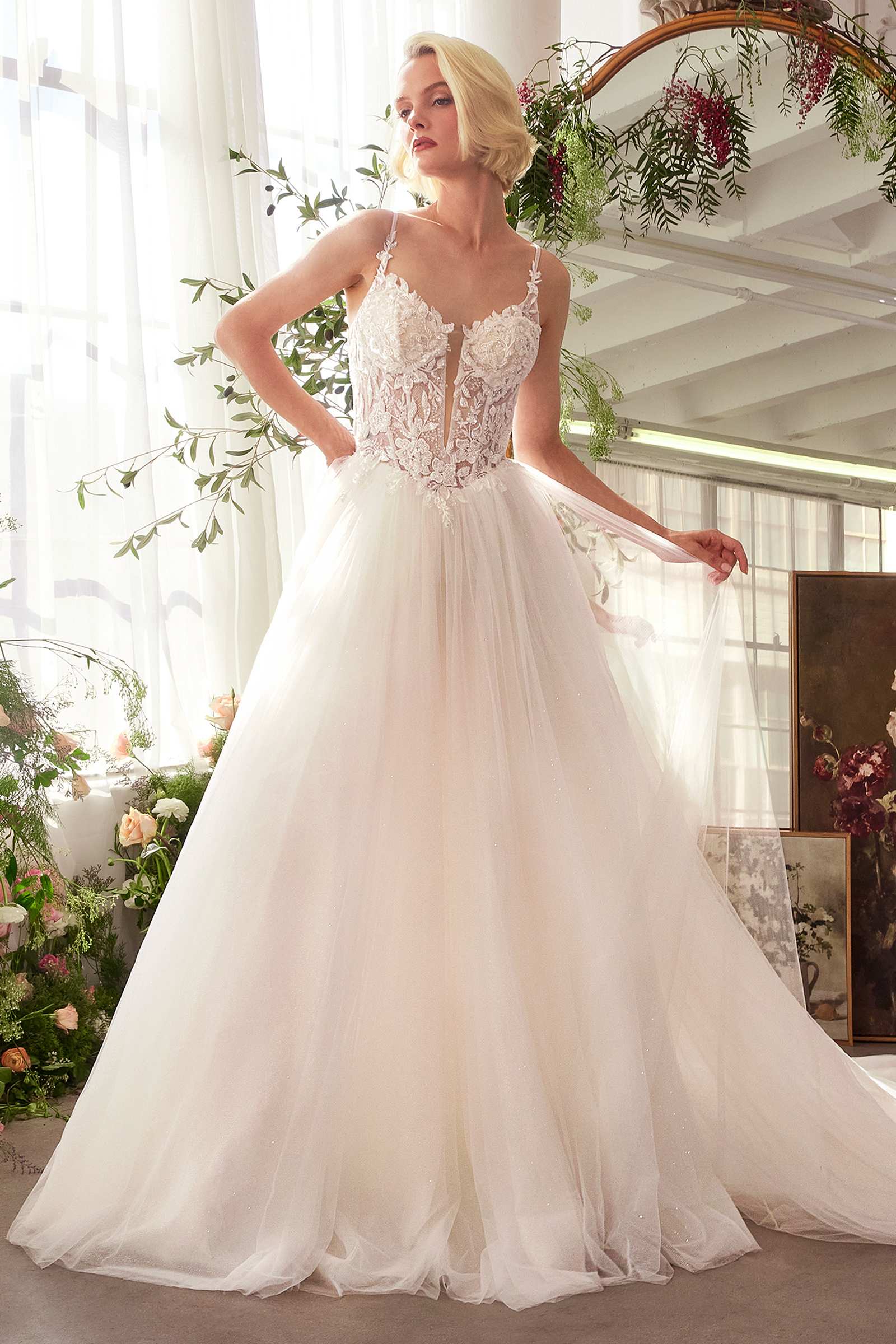 Off-white bridal ball gown with lace bodice, spaghetti straps, and tulle skirt