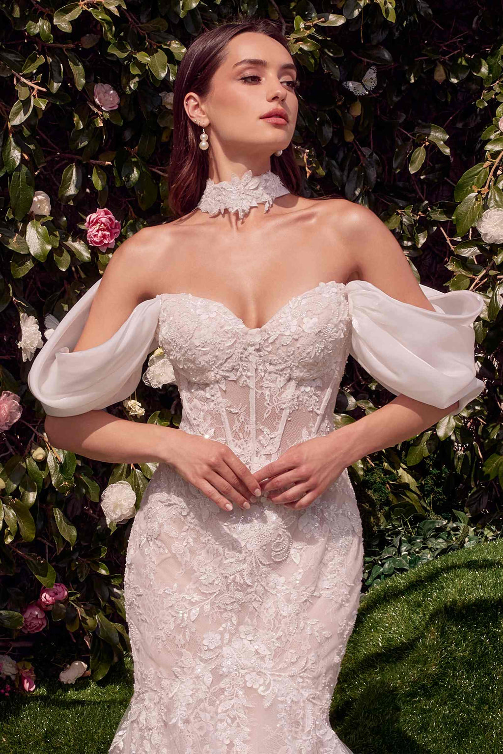 Off-white lace wedding dress with corset bodice, off-shoulder wing sleeves, and ruffled neckline