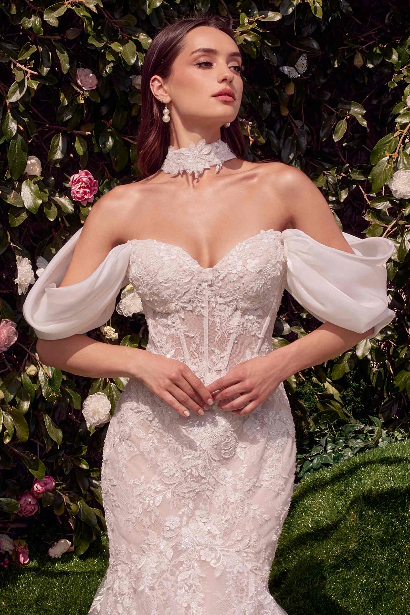 Off-white lace wedding dress with corset bodice, off-shoulder wing sleeves, and ruffled neckline